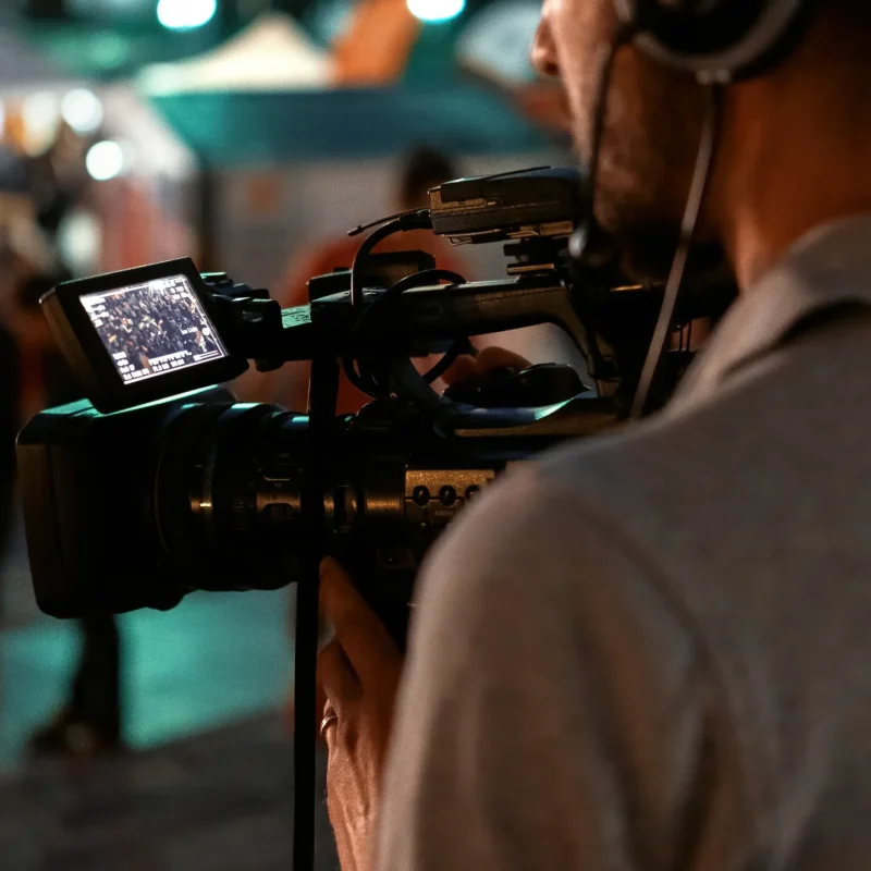 professional-cameraman-recording-poeple-watching-football-public-place-night