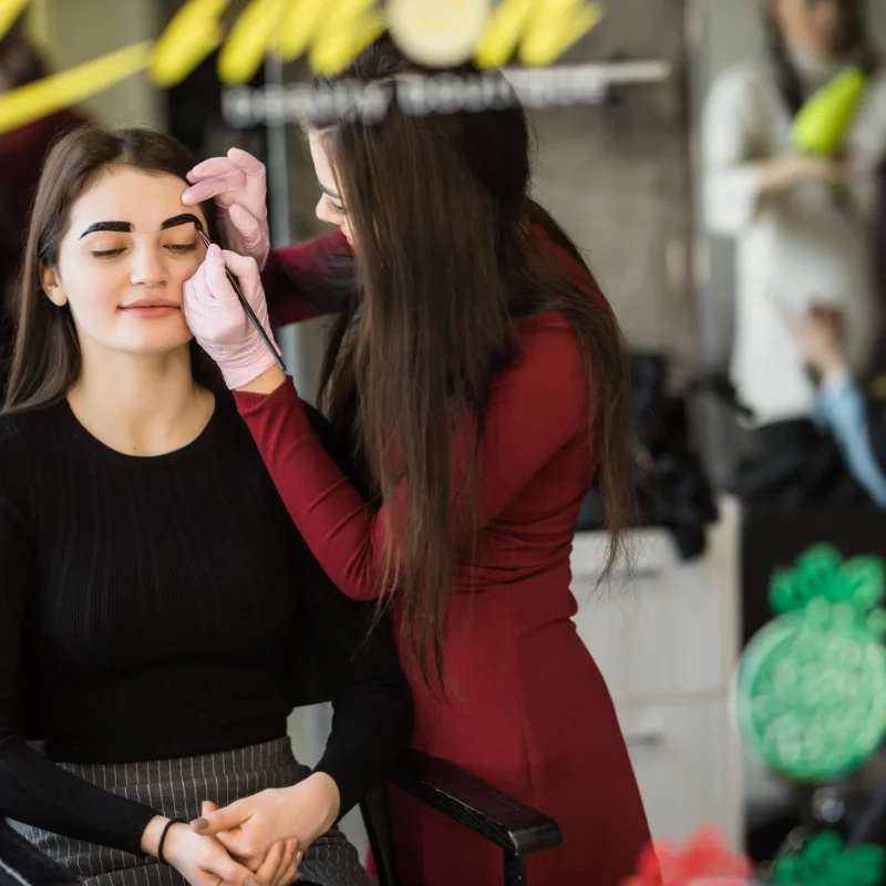 two-girls-are-doing-make-up-front-big-professional-mirror